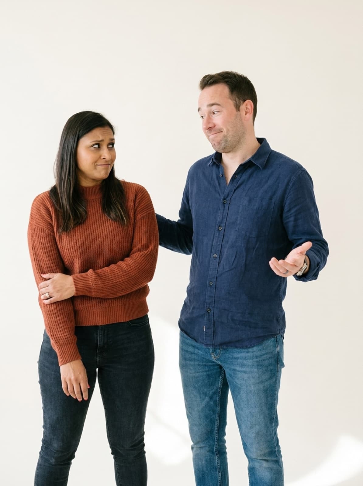 Melissa giving Rami a skeptical sideways look while he shrugs, mock-innocent